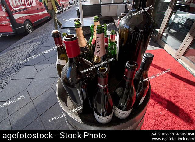 22 February 2021, Berlin: Empty drink bottles stand as decoration in front of a gastronomic establishment not far from the Gendarmenmarkt