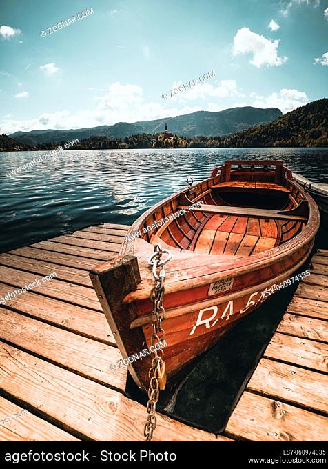 Traditional wooden boats Pletna on the backgorund of Church on the Island on Lake Bled, Slovenia. Europe in summer