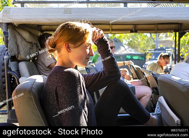 Teenage girl in safari vehicle, Okavango Delta, Botswana