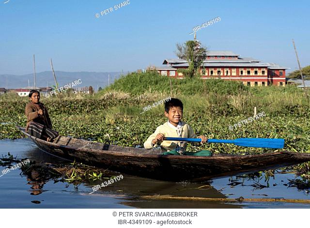 Intha people, woman and child rowing boat on Inle Lake, Burma, Myanmar