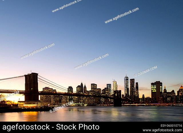 New York, United States of America - November 18, 2016: Skyline of Lower Manhattan with Brooklyn Bridge at sunset