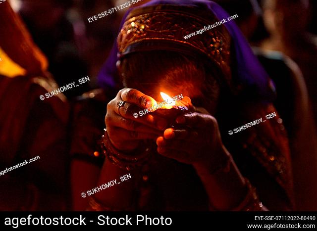 November 7, 2022, Kolkata, India: A woman prays to God on the occasion of Dev Deepavali, is the festival of Kartik Poornima, mainly celebrated in Varanasi