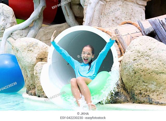 Cheerful Girl Enjoying on Water Slide at Aquapark