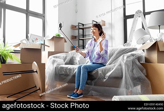 woman having video call and moving into new home