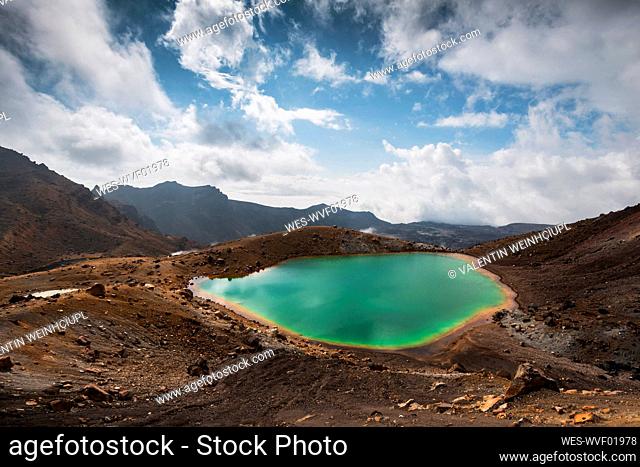 New Zealand, Ruapehu District, Clouds over green hot spring in Tongariro National Park