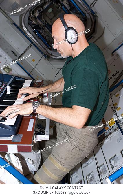 European Space Agency astronaut Luca Parmitano, Expedition 36 flight engineer, plays a keyboard instrument in the Unity node during some of his off-duty time...