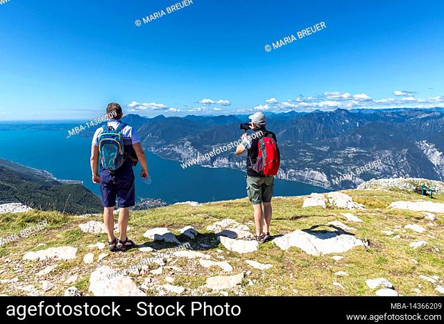 Two tourists enjoying the view, Monte Baldo, Malcesine, Lake Garda, Italy, Europe