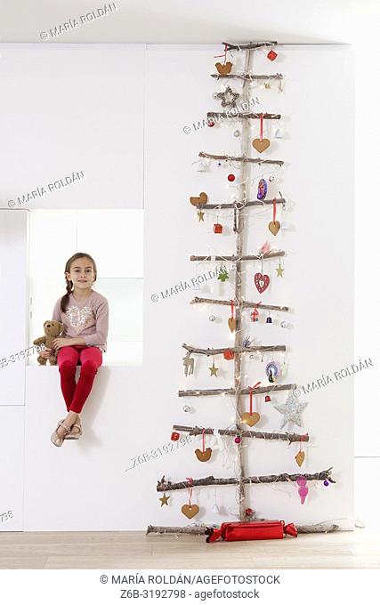 Modern Christmas tree and little girl