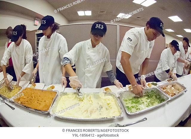 Volunteers for the Salvation Army serve Thanksgiving Dinner to the neediest at the N Y Temple in New York The Salvation Army expects to feed several thousand...