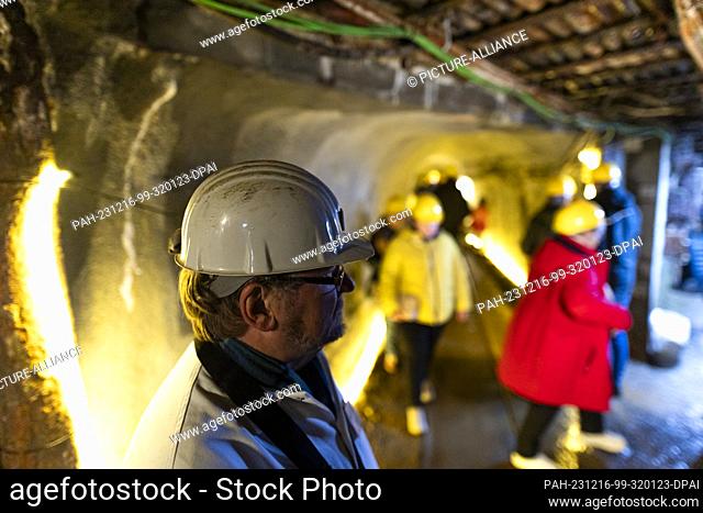 16 December 2023, Lower Saxony, Goslar: A mine guide wearing a hard hat stands in a gallery of the Rammelsberg Mining Museum