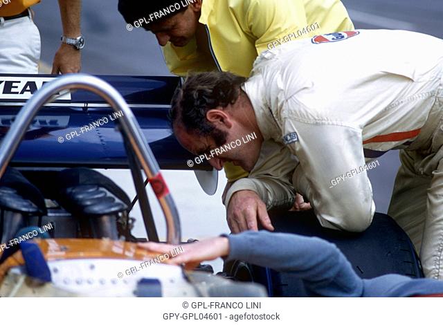 Denny Hulme looking at the engine of his carat the Questor GP in Ontario 1971