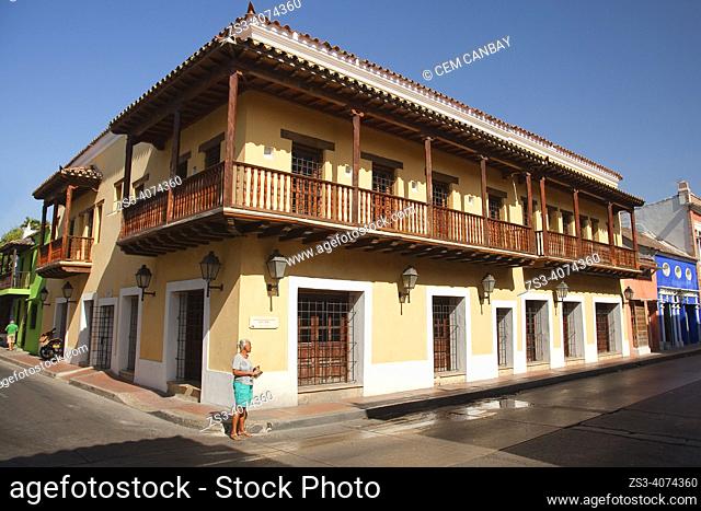 Woman in front of the colonial buildings with balconies at Getsemani district in the historic center, Cartagena de Indias, Bolivar, Colombia, South America