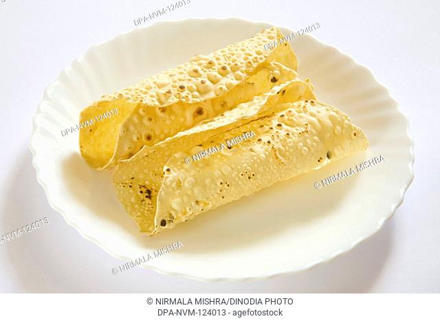 Indian Food Papad , Poppadoms are Round Wafer-thin Discs made of various Lentil or Cereal Flours Served Roasted or Deep Fried , India