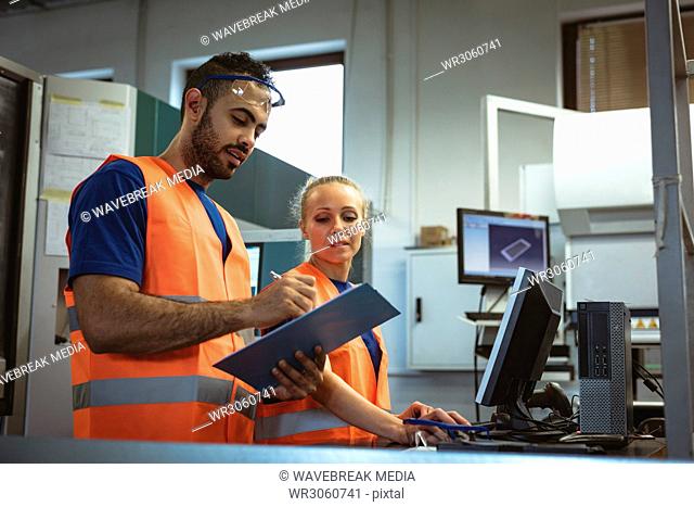 Two worker discussing over clipboard