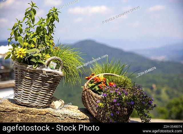 A basket with flowers at pilgrimage village of Santa Maria del Monte on Sacro Monte di Varese, UNESCO World Cultural Heritage Site, Santa Maria del Monte
