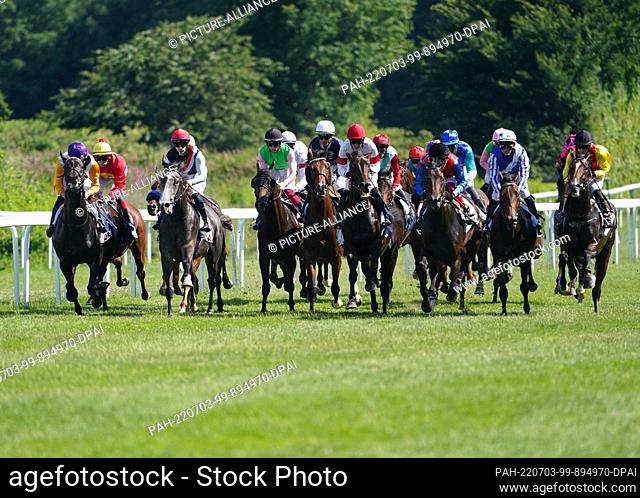 03 July 2022, Hamburg: Horse racing: Gallop, 153rd German Derby at the Horner racecourse. The participants of the German Derby run past the grandstand
