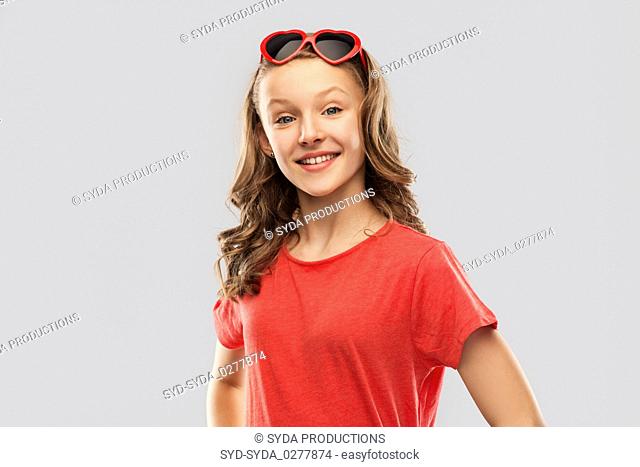 happy teenage girl in red heart shaped sunglasses