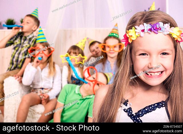 Happy smiling children celebrating birthday party at home