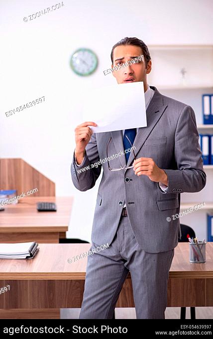 The unhappy male businessman in the office