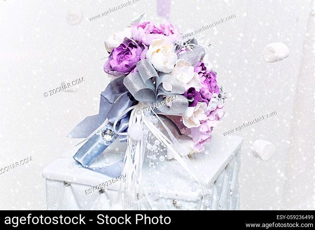 Beautiful hand made art clay bridal bouquet with purple and silver flowers lying on white side table. Copy space