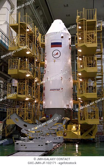 With the Soyuz TMA-08M spacecraft safely nestled inside, the upper stage of a Soyuz booster rocket stands at the ready in the Integration Facility at the...