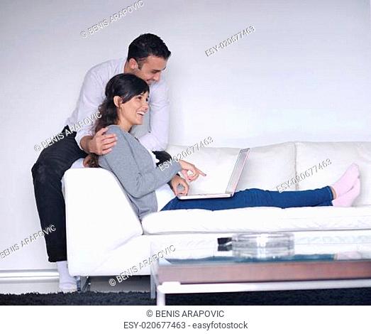 Relaxed young couple watching tv at home