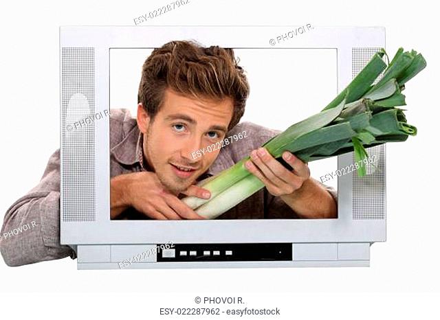 a man giving leeks through a screen