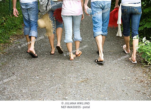 Friends wearing jeans walking, Sweden