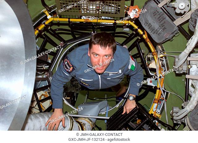Soyuz Taxi Flight Engineer Roberto Vittori of the European Space Agency (ESA) moves through the Zvezda Service Module's transfer compartment on the...