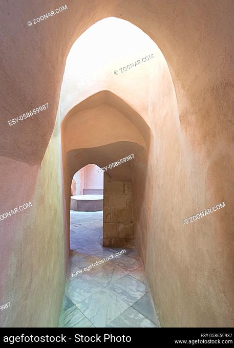 Aged narrow dark stone vaulted passage at ottoman era public Turkish historical traditional Hamam Inal bathhouse, Moez Street, Cairo, Egypt