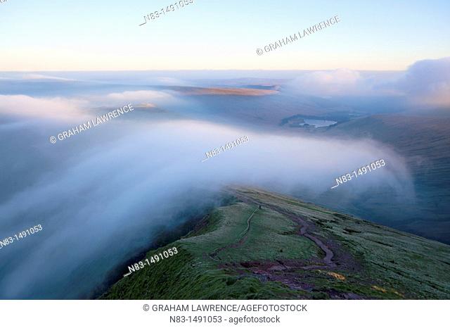 Orographic cloud forms around the summit of Pen-Y-Fan in The Brecon Beacons National Park, Powys, Wales, UK