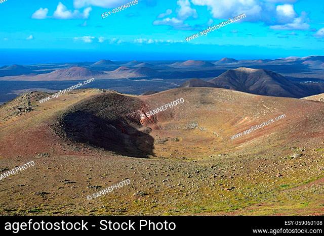 Top view to a crater. View from the mountain Atalaya de Femes near Femés. Lanzarote, Canary Islands, Spain. Timanfaya National park and Volcano Nature Park in...