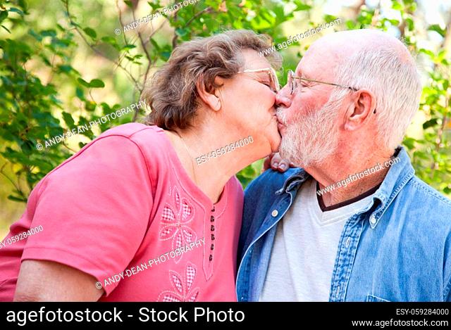 Loving Senior Couple Kissing and Enjoying the Outdoors Together