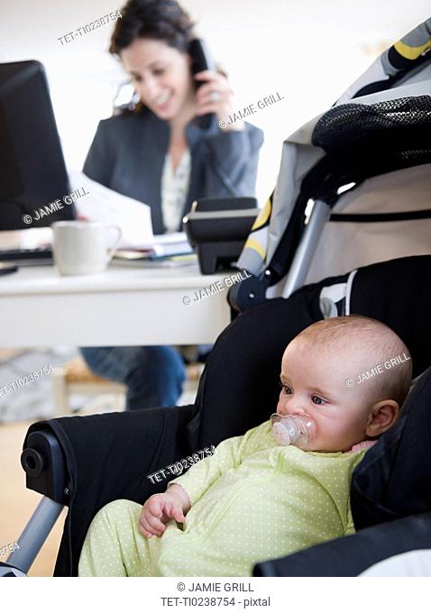 Mother with baby boy 2-5 months working from home