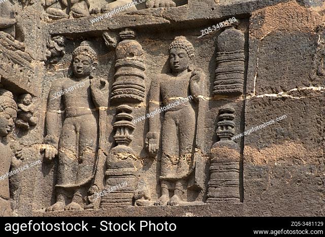 Ajanta Caves, Aurangabad, Maharashtra, India Cave No. 19 left of façade Buddhas in Varada mudra with low relief stupas in between