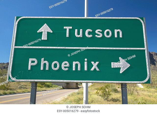 A interstate highway sign in Arizona directing traffic to Tucson and Phoenix, AZ
