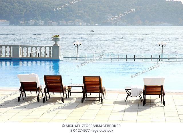 Sun loungers and swimming pool, Ciragan Palace Kempinski, luxury hotel on the Bosphorus, Bogazici, Besiktas district, Istanbul, Turkey