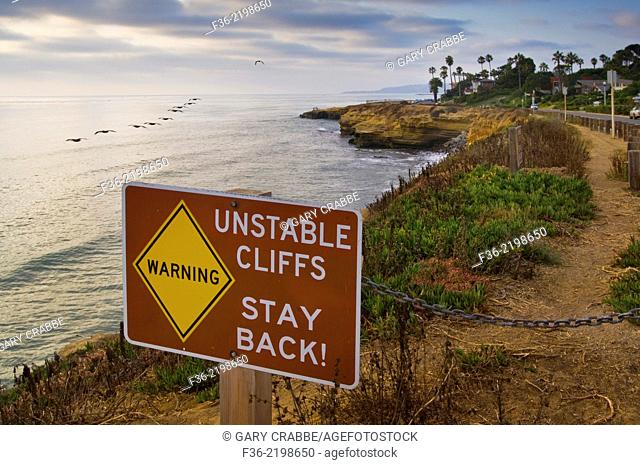 Stay Back Warning sign for unstable coastal cliffs at Sunset , San Diego, California