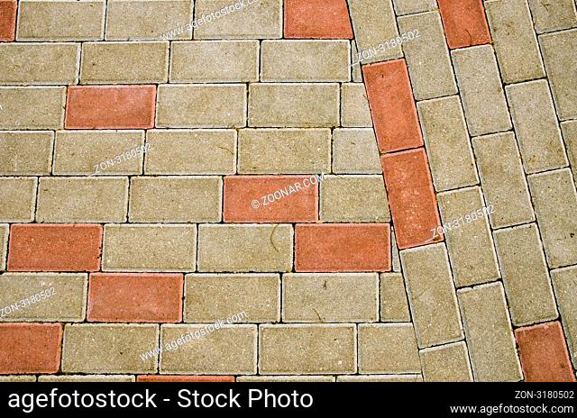City sidewalk lined with small rectangular tile background backdrop