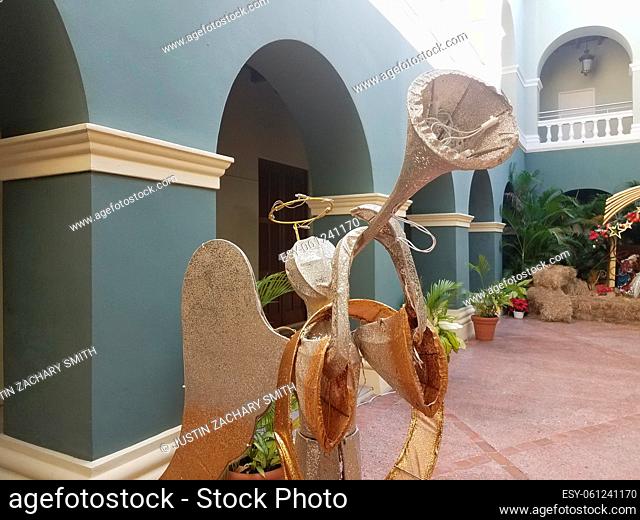 angel blowing a trumpet in Ponce, Puerto Rico and blue walls
