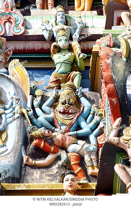 Deity Narasingha killing demon Hiranyashasipu on gopuram of Sri Ranganathswami temple , Srirangam , Tiruchirapalli Trichy , Tamil Nadu , India
