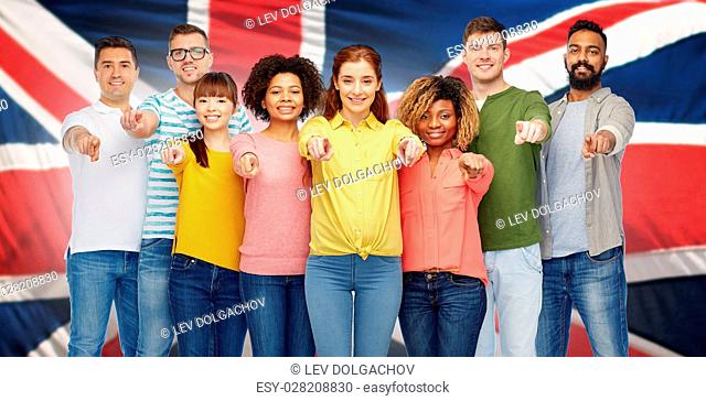 diversity, choice, ethnicity and people concept - international group of happy smiling men and women pointing finger on you over english flag background