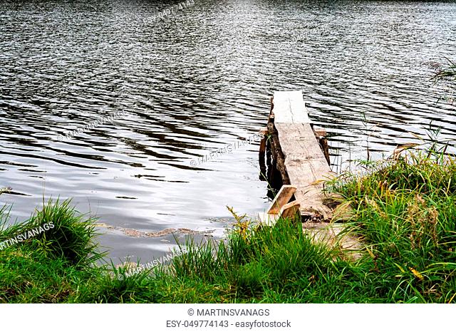 wooden footbridge in the lake in the countryside
