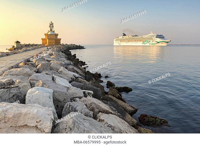 Europe, Italy, Veneto, Venice, Cavallino coast, Cruise ship passing near the lighthouse of Punta Sabbioni