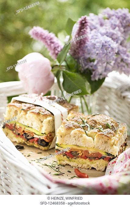 Stuffed focaccia with courgette, tomatoes and olives for summer picnic