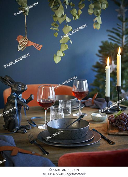 A festively laid table in dark colours
