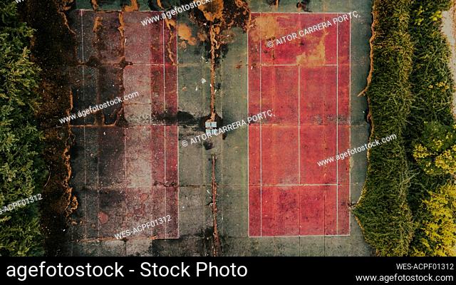 Aerial view of empty abandoned tennis courts