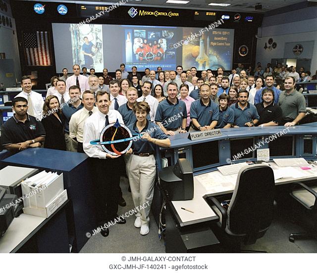The members of the STS-114 Ascent/Entry team and crewmembers pose for a group portrait in the Shuttle (White) Flight Control Room of Houston?s Mission Control...
