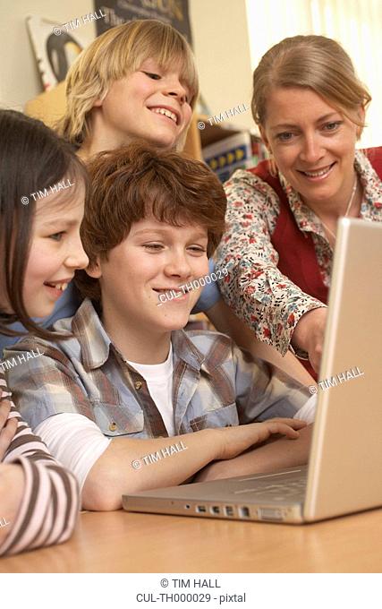Group on computer, smiling