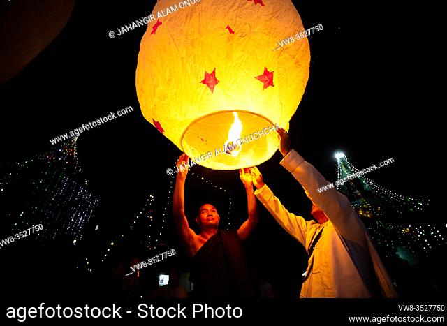 Bangladesh - October 13, 2019: Buddhist devotees people are trying to flying paper lanterns on the occasion of Probarona Purnima festival in Bandarban